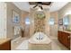 Elegant bathroom with soaking tub, double vanity, and tile shower at 24087 Santa Inez Rd, Punta Gorda, FL 33955