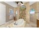 Large bathroom with a luxurious soaking tub and walk-in shower at 24087 Santa Inez Rd, Punta Gorda, FL 33955