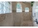 Spa-like bathroom with soaking tub, walk-in shower, and elegant tile at 24087 Santa Inez Rd, Punta Gorda, FL 33955