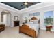 Main bedroom with antique wood bed, fireplace and neutral decor at 24087 Santa Inez Rd, Punta Gorda, FL 33955