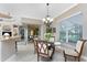 Bright breakfast nook with glass-top table and four chairs at 24087 Santa Inez Rd, Punta Gorda, FL 33955
