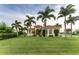 Single-Gathering home with palm trees and a manicured lawn at 24087 Santa Inez Rd, Punta Gorda, FL 33955