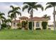 Beautiful home with lush landscaping and palm trees at 24087 Santa Inez Rd, Punta Gorda, FL 33955