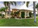 Single-Gathering home with palm trees and a manicured lawn at 24087 Santa Inez Rd, Punta Gorda, FL 33955