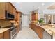 Open kitchen with granite counters, wood cabinets & island at 24087 Santa Inez Rd, Punta Gorda, FL 33955
