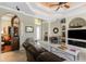 Living room features hardwood floors, built-in shelving, and an arched doorway at 24087 Santa Inez Rd, Punta Gorda, FL 33955