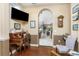 Home office with antique desk, wood floors, and view to living area at 24087 Santa Inez Rd, Punta Gorda, FL 33955