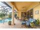 Resort-style pool and patio with seating and lush landscaping at 24087 Santa Inez Rd, Punta Gorda, FL 33955