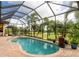 Inviting kidney-shaped pool with screened enclosure and lake view at 24087 Santa Inez Rd, Punta Gorda, FL 33955