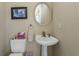 Small half bathroom with pedestal sink and toilet at 24087 Santa Inez Rd, Punta Gorda, FL 33955