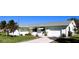 White single story house with a gray roof, driveway, and lawn at 20430 Edgewater Dr, Port Charlotte, FL 33952