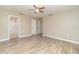 Large bedroom with wood-look floors and access to bathroom at 2931 S Cranberry Blvd, North Port, FL 34286