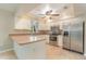 L-shaped kitchen with stainless steel appliances and an island at 2931 S Cranberry Blvd, North Port, FL 34286