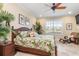 Spacious main bedroom with large window, tropical decor, and ensuite bathroom at 3800 Bal Harbor # 414, Punta Gorda, FL 33950