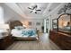 Bright bedroom with decorative wall art, tray ceiling, and a sliding glass door with outdoor access at 4767 Maurbach Ter, North Port, FL 34286