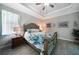 Comfortable bedroom featuring an elegant bed with decorative wooden frame, crown molding, and neutral color scheme at 4767 Maurbach Ter, North Port, FL 34286