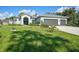 Single-story home with a two-car garage and well-manicured lawn at 4767 Maurbach Ter, North Port, FL 34286