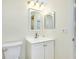 Bathroom with white vanity, toilet and a framed mirror at 1515 Forrest Nelson Blvd # G102, Port Charlotte, FL 33952
