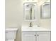Bathroom with white vanity, toilet and a framed mirror at 1515 Forrest Nelson Blvd # G102, Port Charlotte, FL 33952