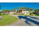 Tan colored building with palm trees and lush landscaping at 1515 Forrest Nelson Blvd # G102, Port Charlotte, FL 33952