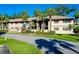 Tan colored building with palm trees and lush landscaping at 1515 Forrest Nelson Blvd # G102, Port Charlotte, FL 33952