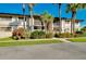 Building exterior with palm trees and well-manicured landscaping at 1515 Forrest Nelson Blvd # G102, Port Charlotte, FL 33952