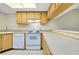 Kitchen with light wood cabinets and white appliances at 1515 Forrest Nelson Blvd # G102, Port Charlotte, FL 33952
