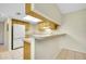 Kitchen with light wood cabinets, white appliances, and a breakfast bar at 1515 Forrest Nelson Blvd # G102, Port Charlotte, FL 33952