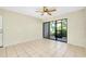 Living room with tile floors, sliding glass doors, and ceiling fan at 1515 Forrest Nelson Blvd # G102, Port Charlotte, FL 33952