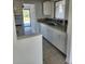 Kitchen featuring white cabinets, stainless steel appliances, and a tile backsplash at 8274 Herbison Ave, North Port, FL 34287