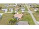 Aerial view of single-Gathering home with pool and landscaped yard in residential neighborhood at 1438 Vermouth Ln, Punta Gorda, FL 33983