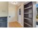 Bright entryway with wood floors, built-in shelving, and exterior door at 1507 Lavilla Rd, Punta Gorda, FL 33950