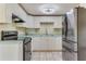 Kitchen with white cabinets, stainless steel appliances, and light countertops at 1507 Lavilla Rd, Punta Gorda, FL 33950