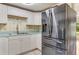 Kitchen with stainless steel refrigerator and white cabinets at 1507 Lavilla Rd, Punta Gorda, FL 33950