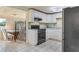 Kitchen features white cabinets, stainless steel appliances, and a dining area at 1507 Lavilla Rd, Punta Gorda, FL 33950