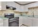White kitchen cabinets, stainless steel appliances and light countertops at 1507 Lavilla Rd, Punta Gorda, FL 33950