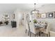 Bright dining area with modern chandelier and access to laundry at 107 Santarem Cir, Punta Gorda, FL 33983