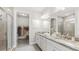 Spa-like bathroom with double vanity, large mirror, and walk-in shower at 16024 Crofton Springs Way, Port Charlotte, FL 33953