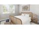 Bright bedroom with a light-wood bed frame and neutral decor at 16024 Crofton Springs Way, Port Charlotte, FL 33953