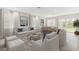 Bright and airy living room with access to backyard, contemporary furnishings, and large windows at 16024 Crofton Springs Way, Port Charlotte, FL 33953