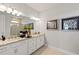 Double vanity bathroom with granite countertops and updated fixtures at 16130 Highgate St, Port Charlotte, FL 33953