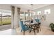 Bright dining room with glass table and seating for six, overlooking the backyard at 16130 Highgate St, Port Charlotte, FL 33953
