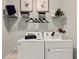 Laundry room with washer, dryer, and ample shelving at 16130 Highgate St, Port Charlotte, FL 33953