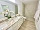 Elegant bathroom with double vanity, granite countertop, and a walk-in shower at 3140 Sweet Gum Dr, Punta Gorda, FL 33982