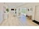 Bright dining area featuring an open concept living space and light colored wood flooring at 3140 Sweet Gum Dr, Punta Gorda, FL 33982