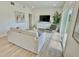 Inviting living area featuring a comfortable couch, entertainment center and bright daylight at 3140 Sweet Gum Dr, Punta Gorda, FL 33982