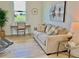 Comfortable seating area with a cozy couch, desk and chair, and decorative wall art at 3140 Sweet Gum Dr, Punta Gorda, FL 33982