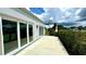 Back patio with sliding glass doors overlooking a garden at 3140 Sweet Gum Dr, Punta Gorda, FL 33982