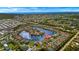 Aerial view showcases a waterfront community with lake, ocean in background and a home pin highlighted at 24723 Rio Villa Lakes Cir, Punta Gorda, FL 33950