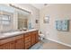Bathroom features a double vanity with tile floors and shower with glass doors at 24723 Rio Villa Lakes Cir, Punta Gorda, FL 33950